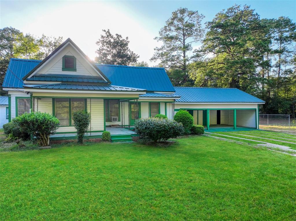 a front view of a house with a garden and porch