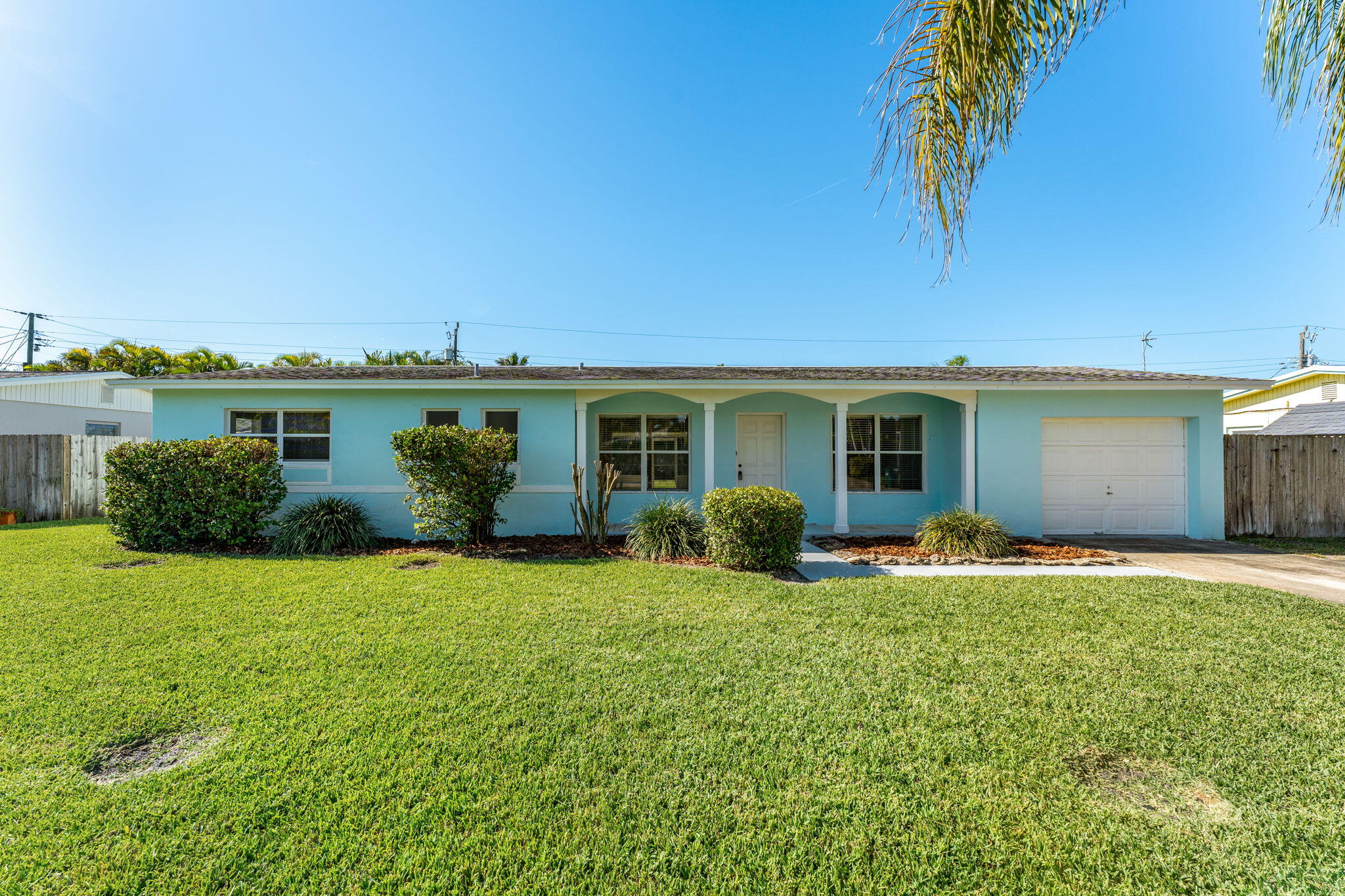 a view of a house with a yard and a patio