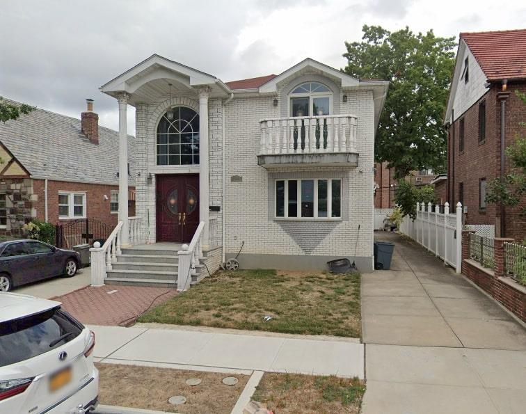 View of front of house featuring a balcony