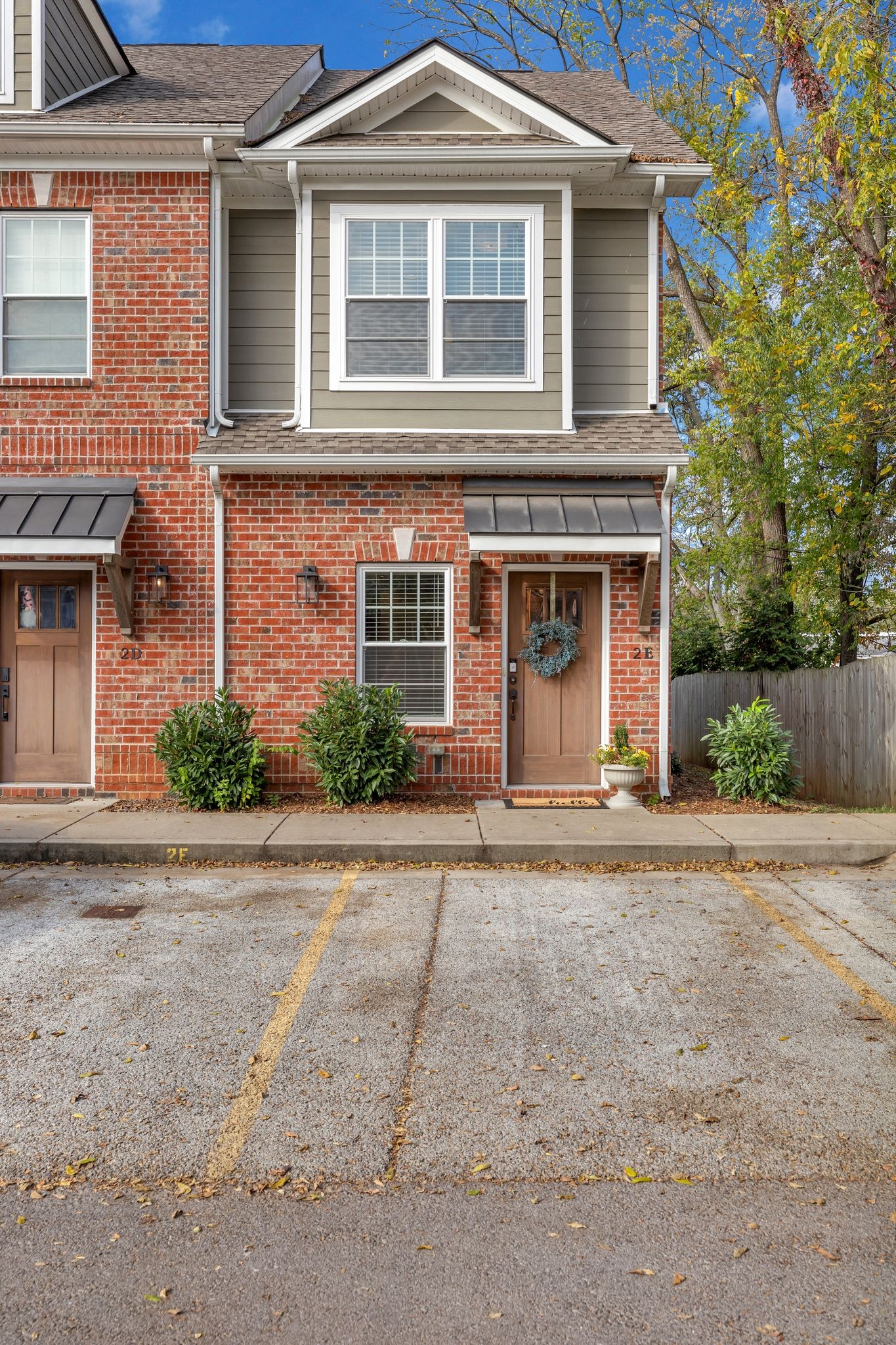 a front view of a house with a yard and a garage