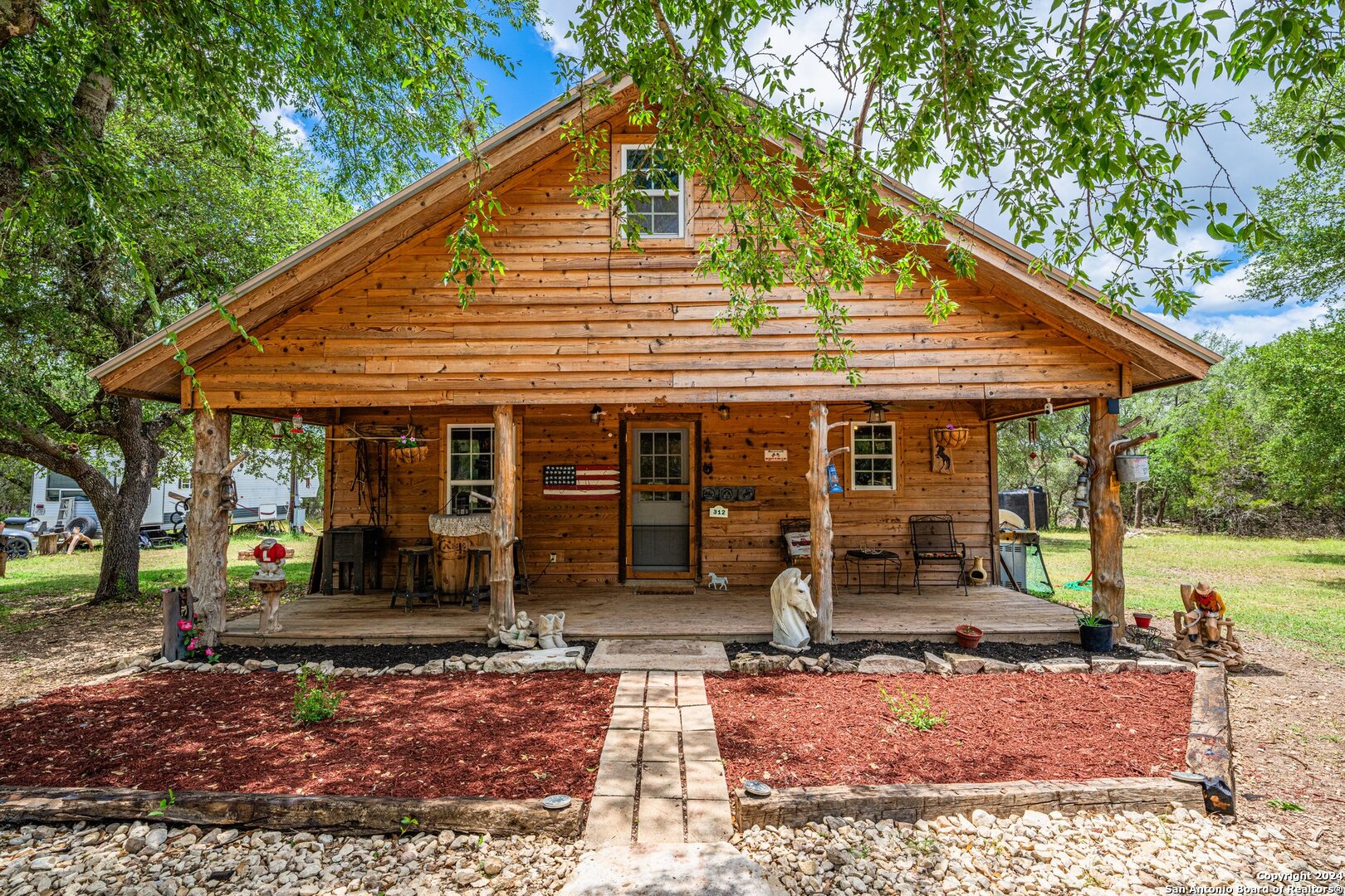 a view of a house with backyard porch and sitting area