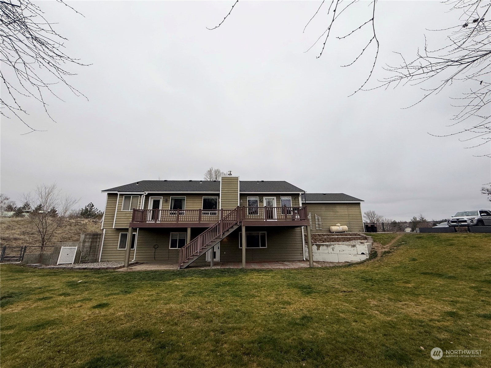 a view of a house with a yard and sitting area