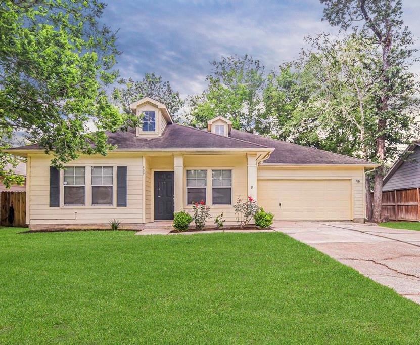 a front view of house with yard and green space