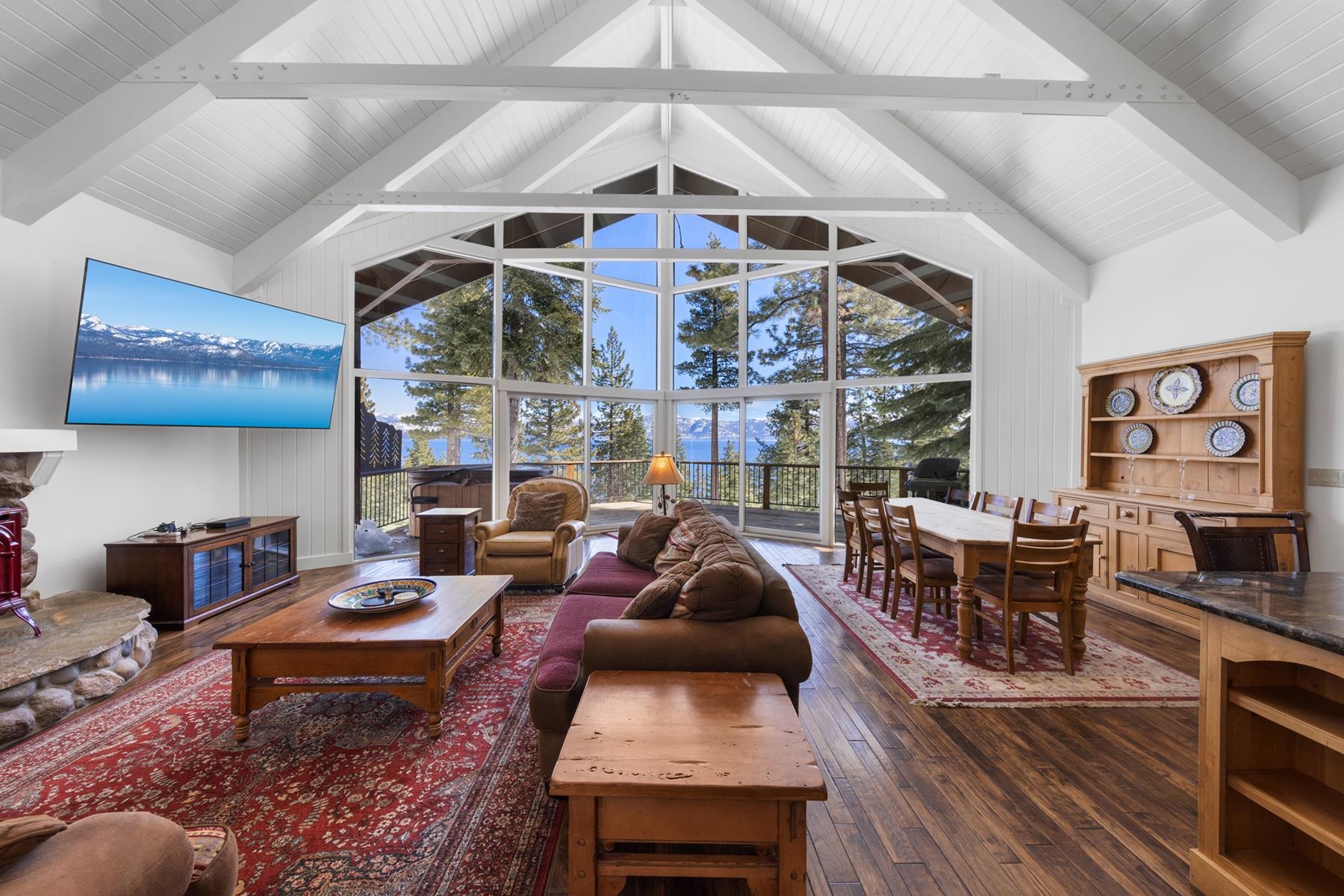 a living room with fireplace furniture and a large window