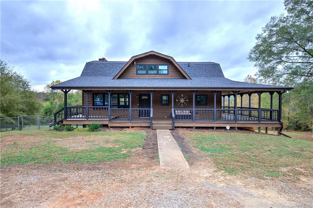 a front view of a house with yard porch and furniture