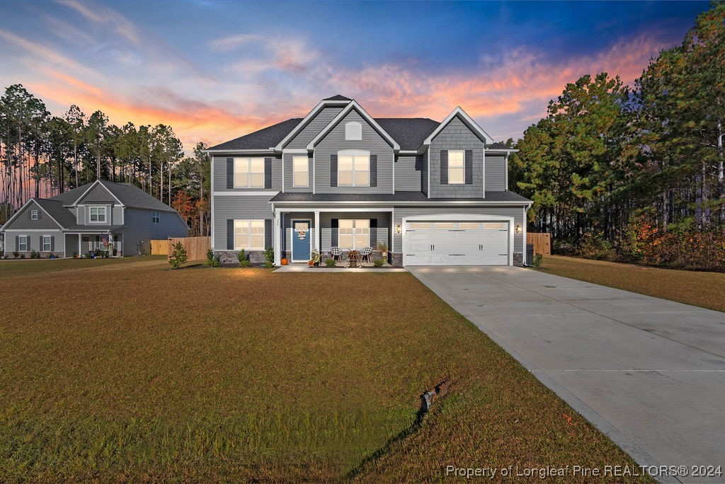 a front view of a house with a yard and garage