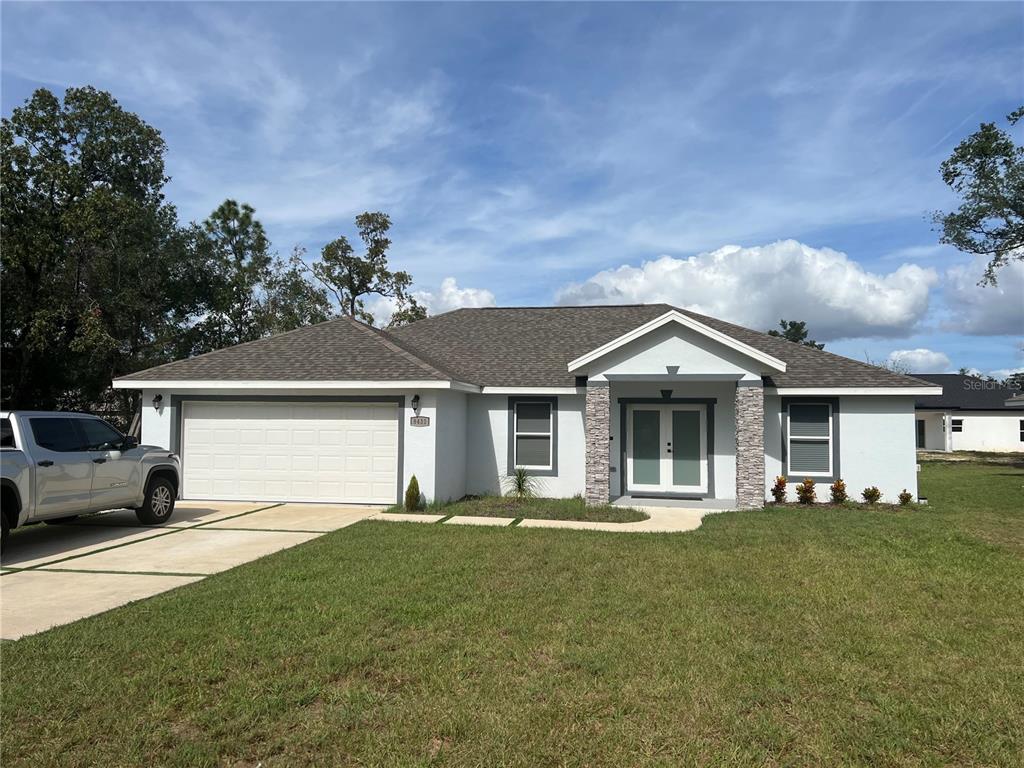 a front view of a house with a garden and yard