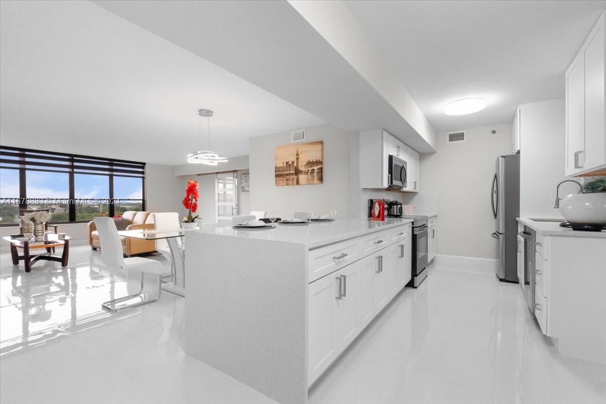 a large white kitchen with lots of counter top space