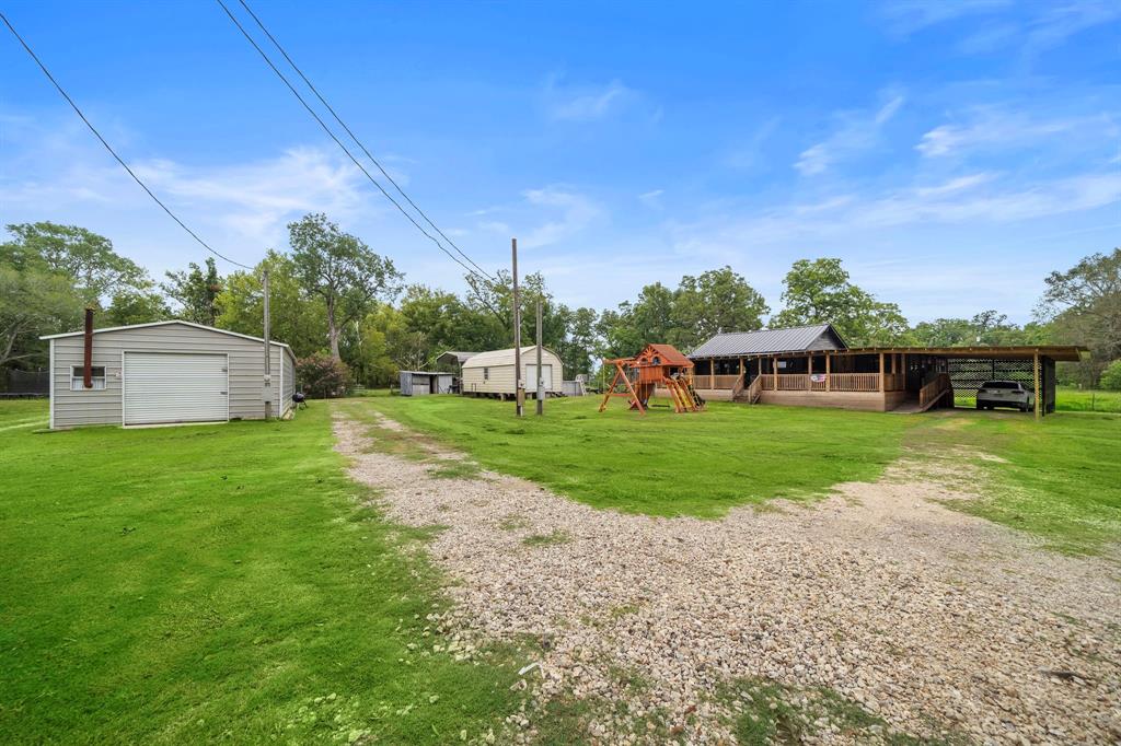 a view of a house with backyard and sitting area