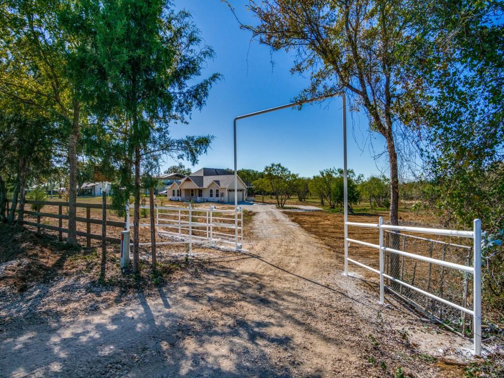 a view of a backyard with wooden fence