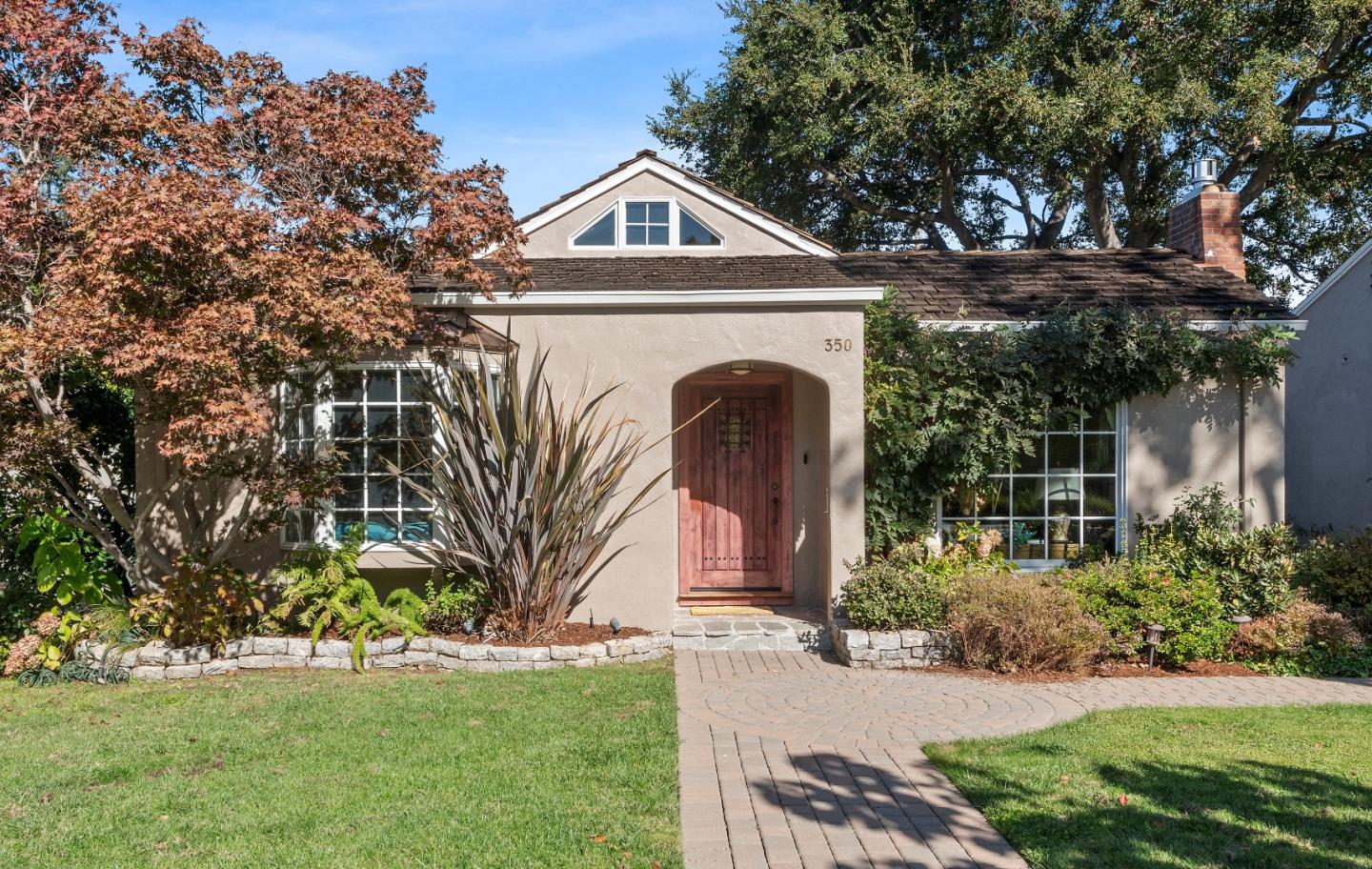 a front view of a house with a garden