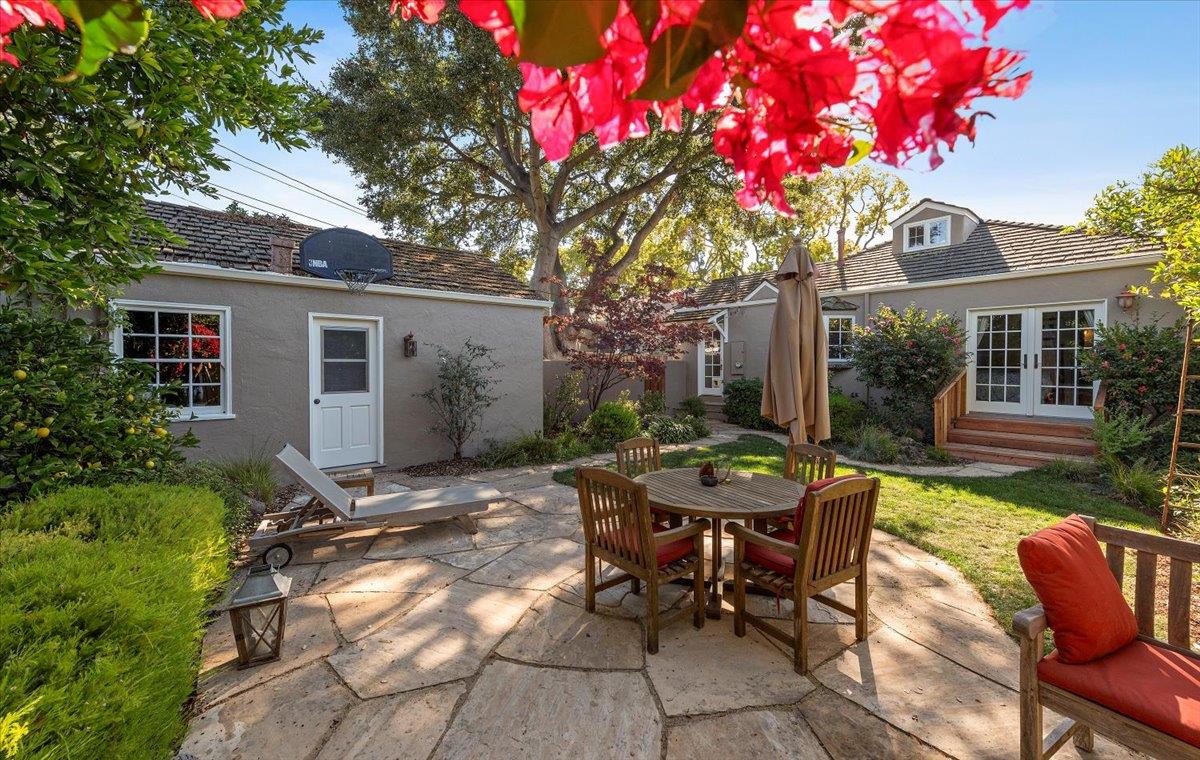 a view of a house with backyard sitting area and garden