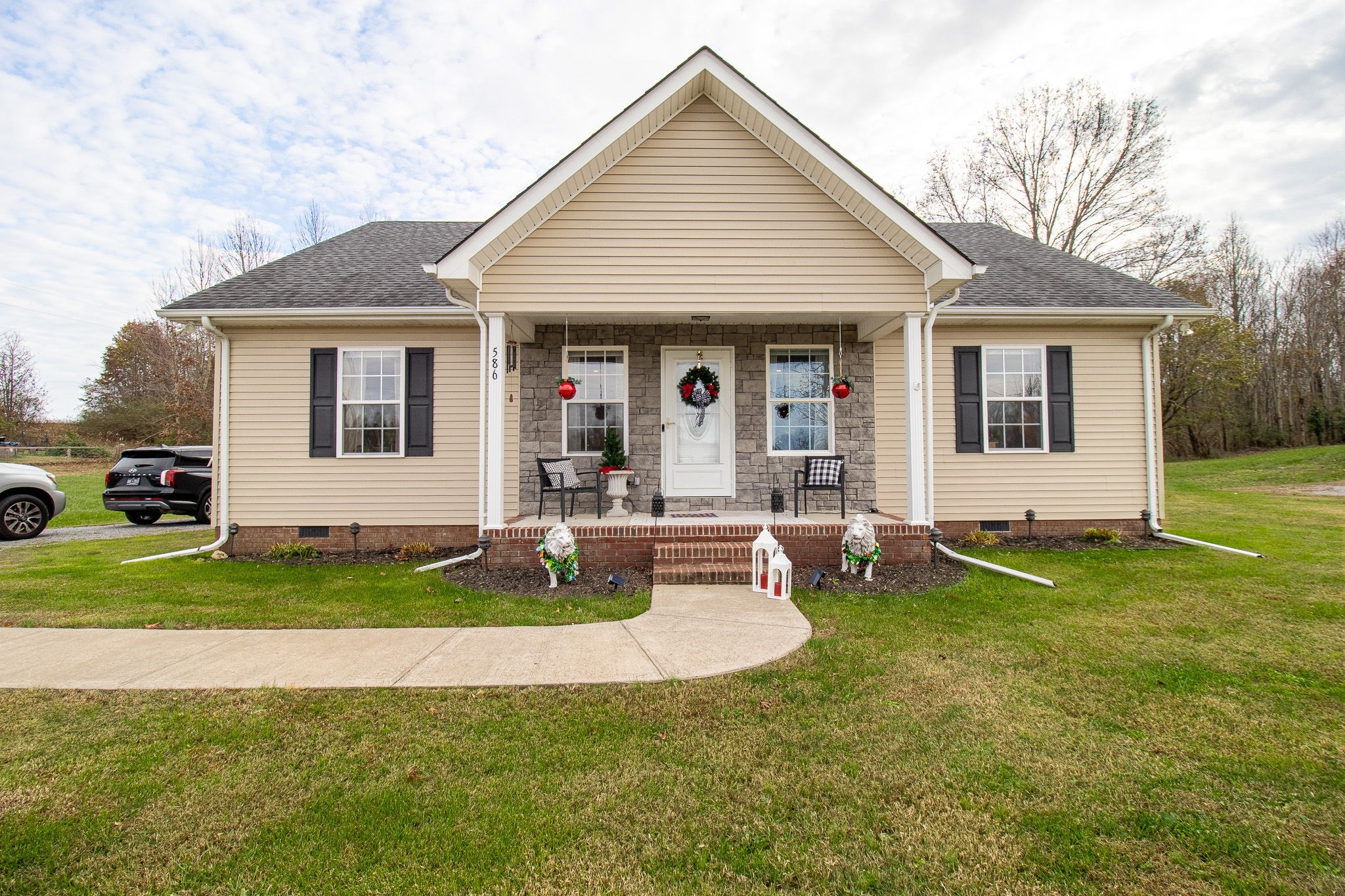 a front view of house with yard and green space