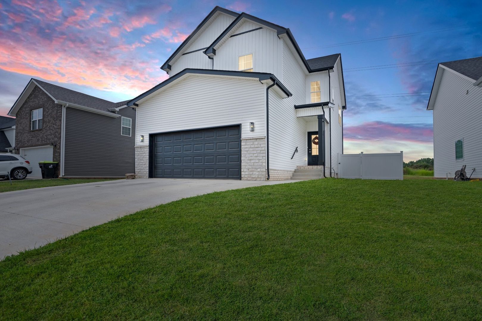 a house with green field in front of it