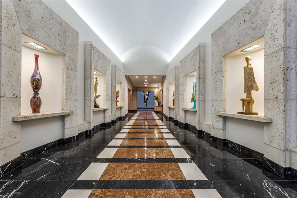 a view of a hallway with wooden floor and furniture