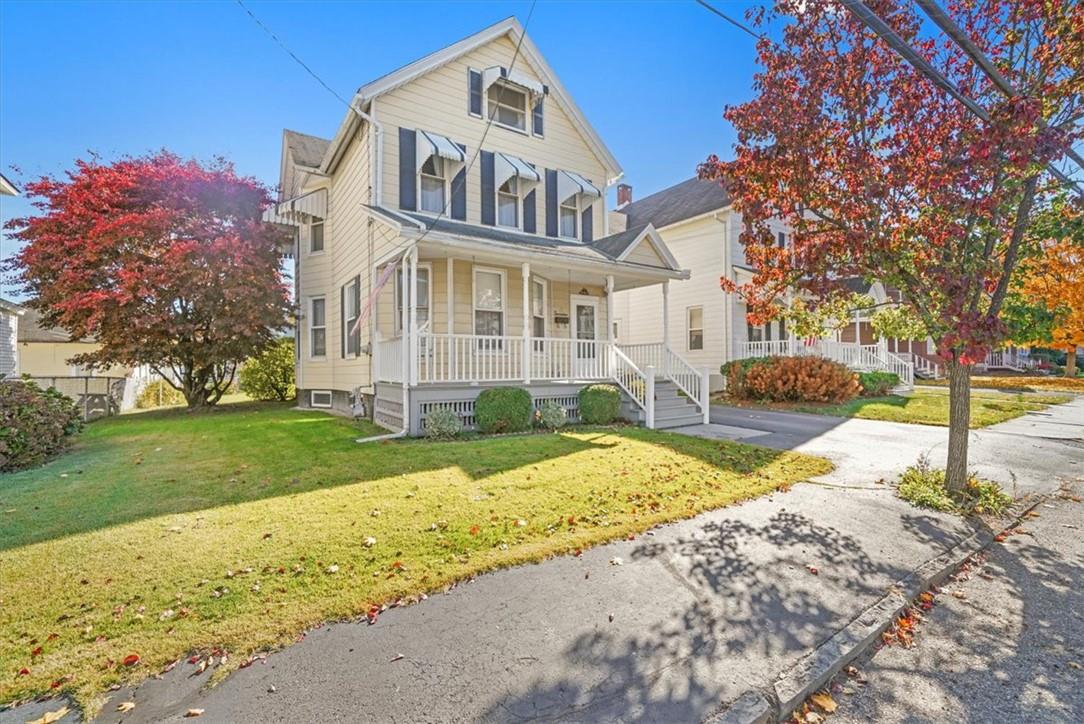 View of front of home featuring a front yard and a porch