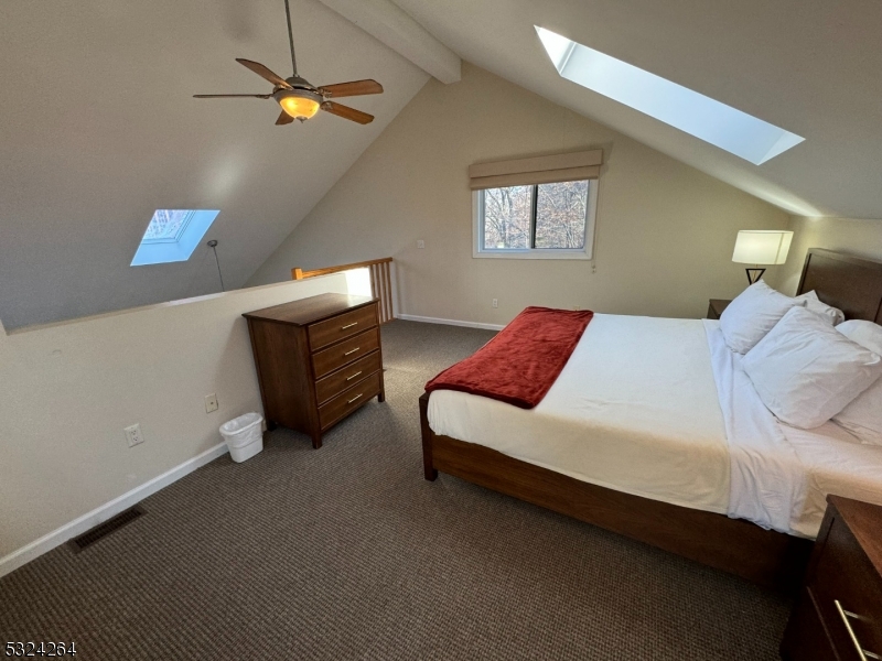 a bedroom with a bed dresser and a window