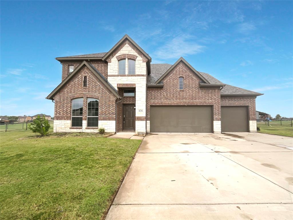 a front door view of a house with a yard