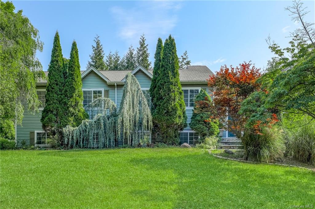 a view of a house with a yard and a fountain