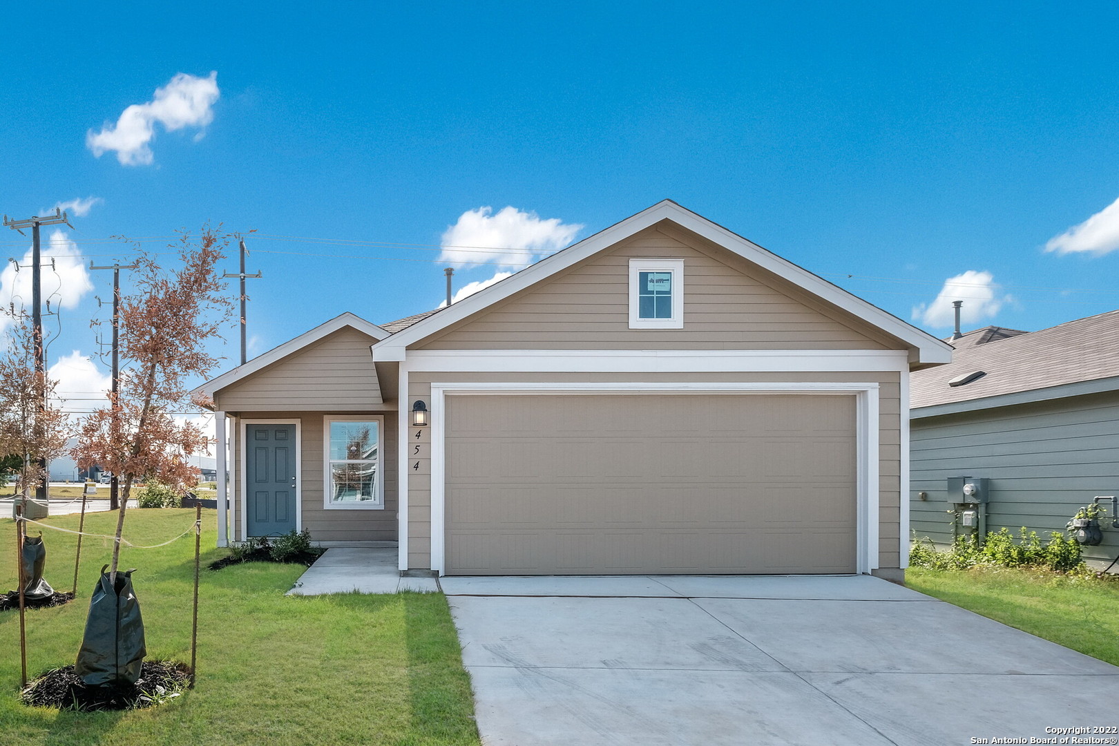 a front view of house with yard and outdoor seating