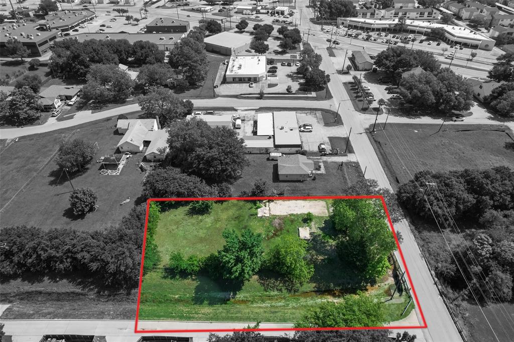 an aerial view of a house with a yard and lake view