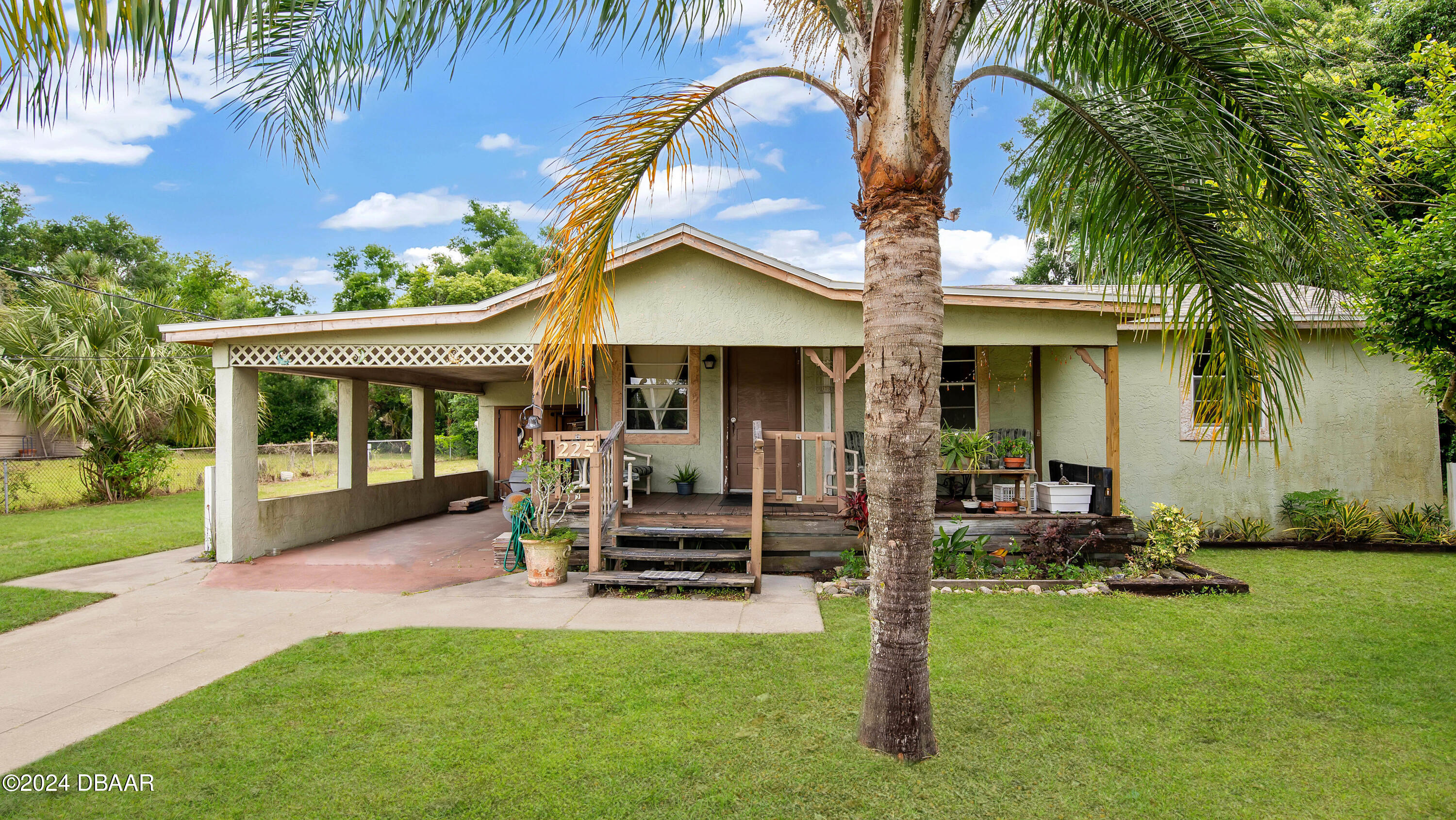 a front view of a house with garden and porch