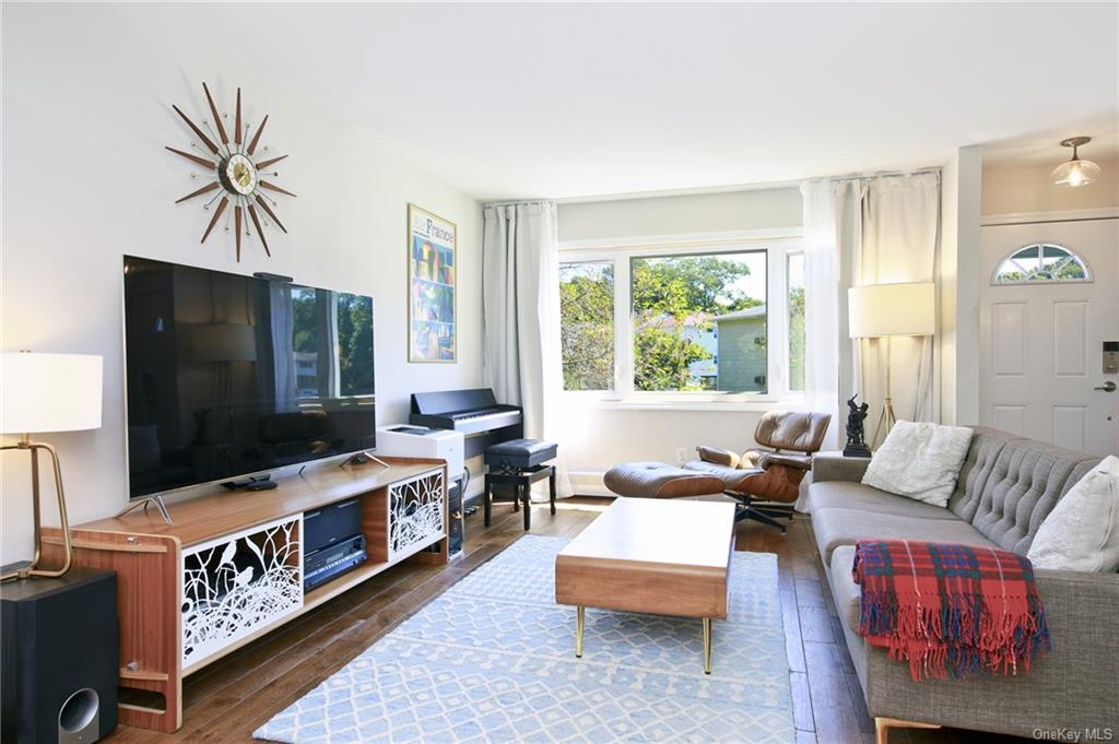 Living room with dark wood-type flooring