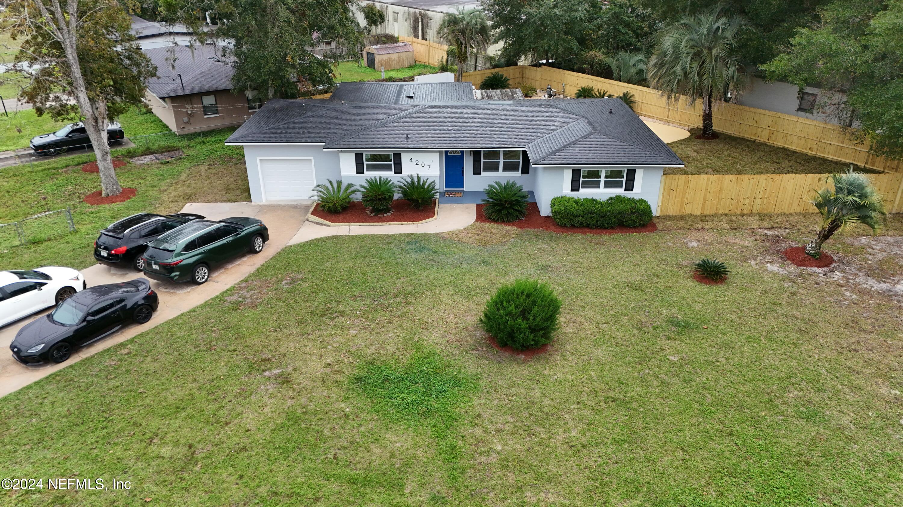 a view of a house with a yard and sitting area