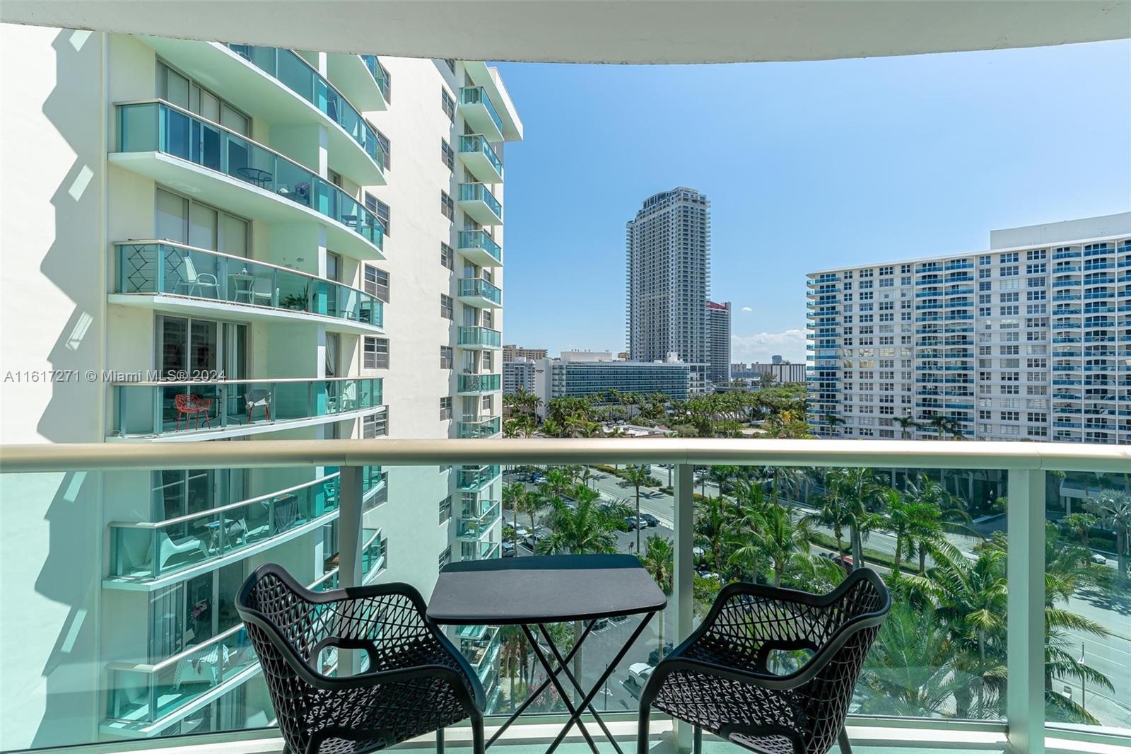 a balcony with table and chairs