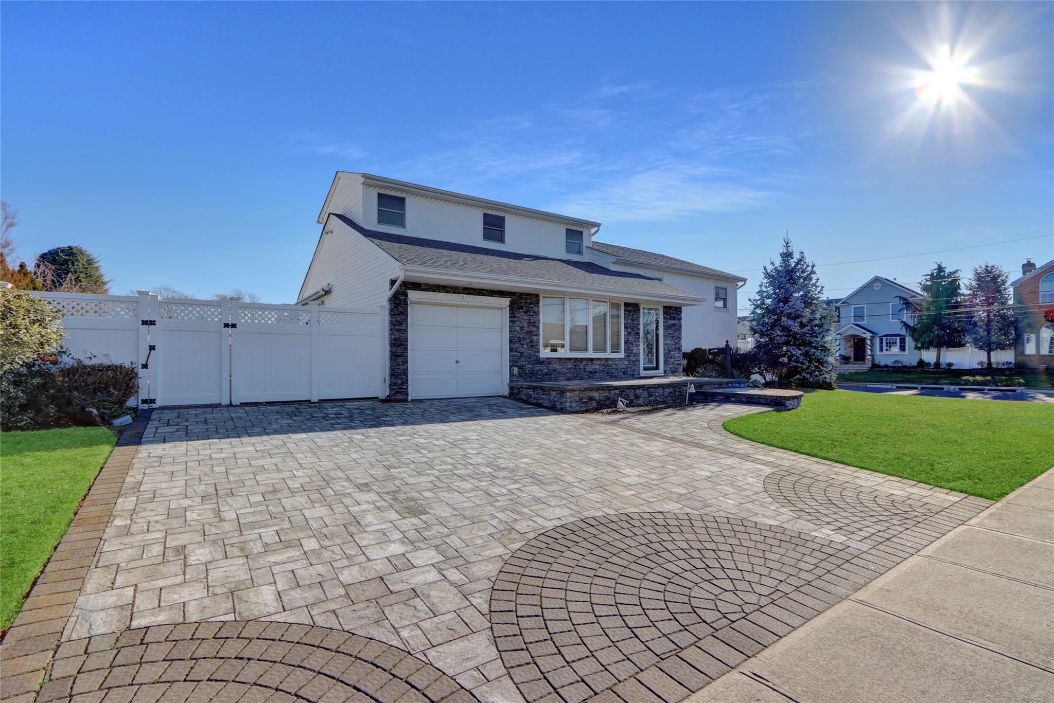 View of front property with a front yard and a garage