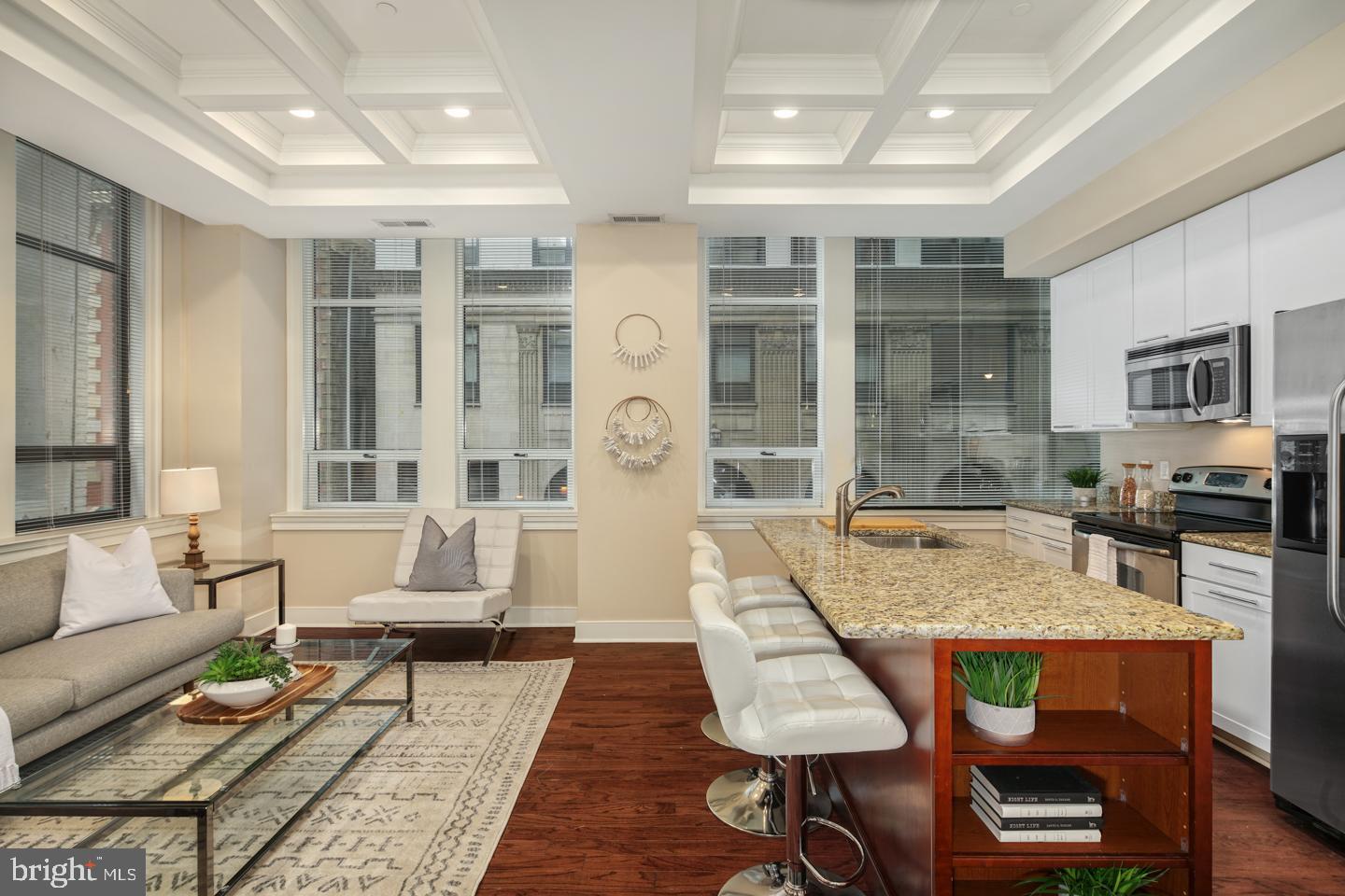 a living room with furniture a rug and a chandelier