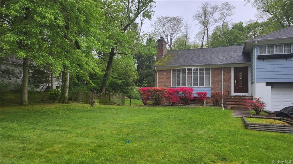 a view of a house with a yard and sitting area