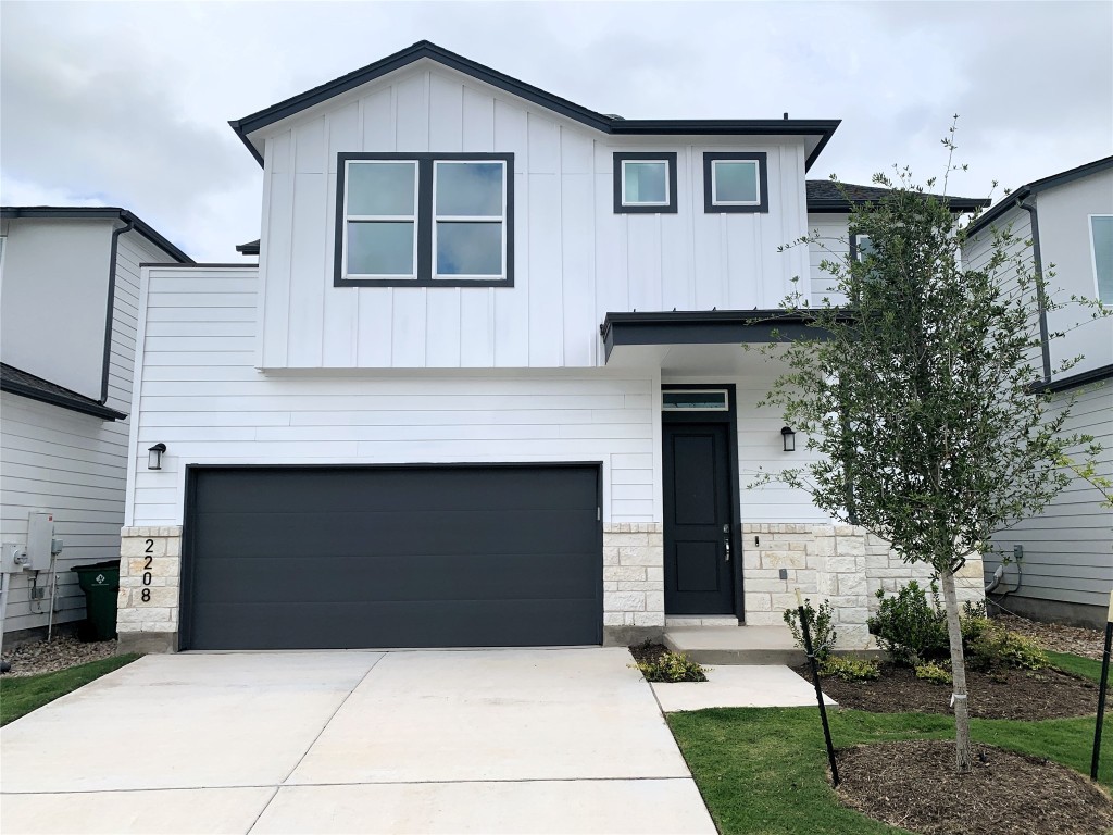 a front view of a house with garage