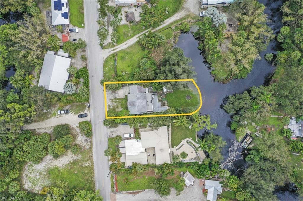 an aerial view of a garden with swimming pool