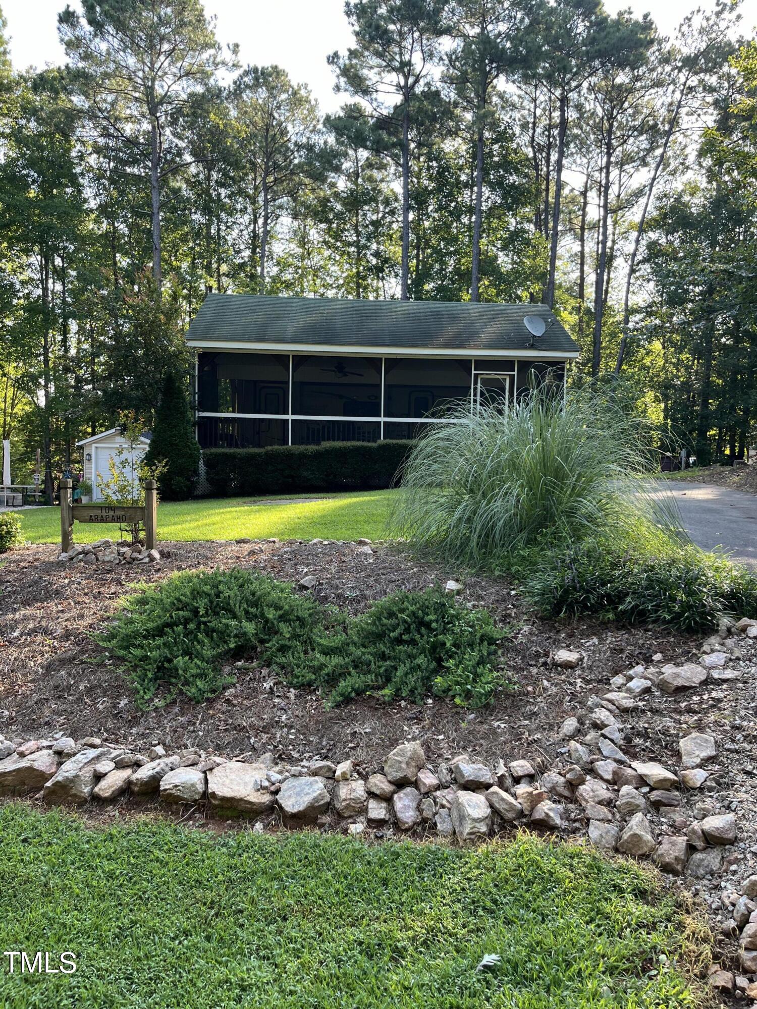 a view of house with backyard and garden