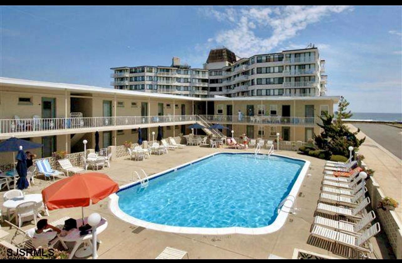 a view of a swimming pool with outdoor seating