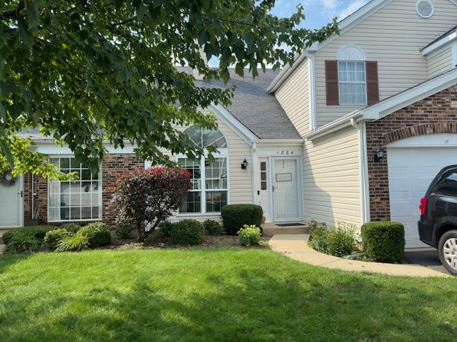 a view of a house with garden and yard