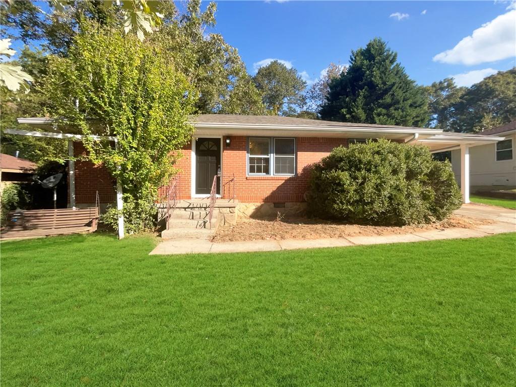 a front view of a house with a yard and trees