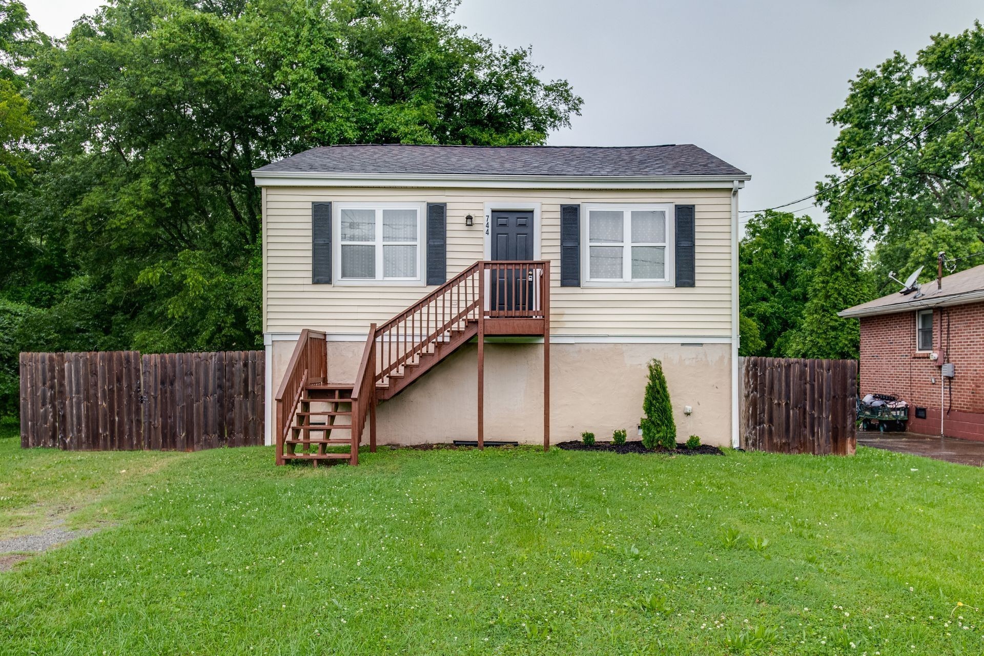 a view of a house with a yard and sitting area