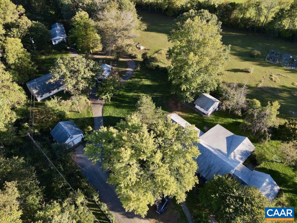 an aerial view of a house with a garden and lake view