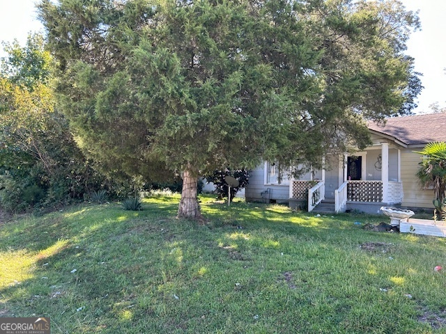 a view of a house with a yard porch and sitting area