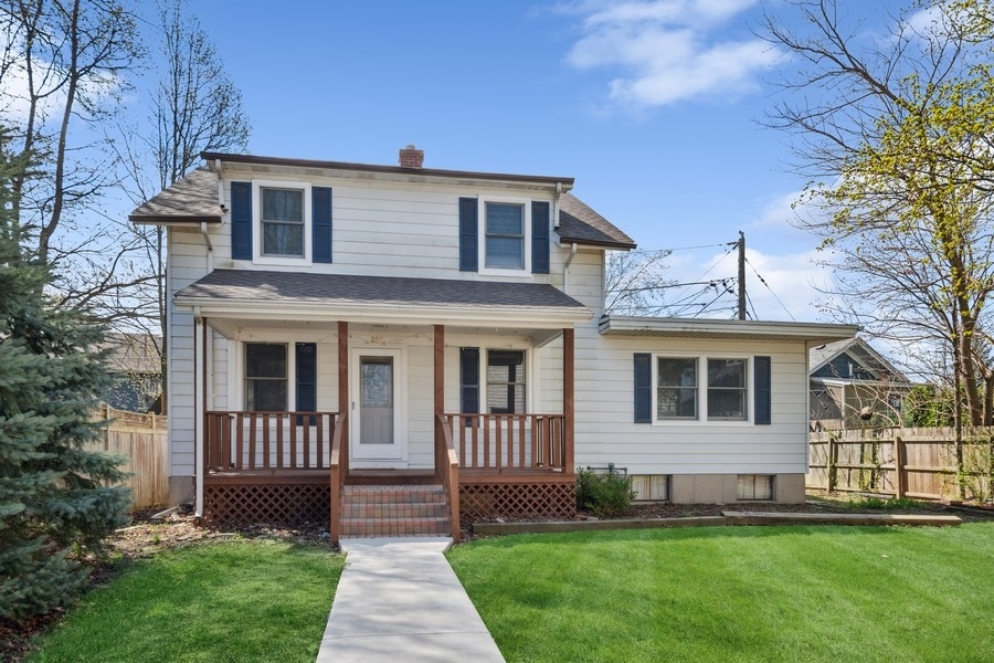 a front view of a house with a yard and outdoor seating