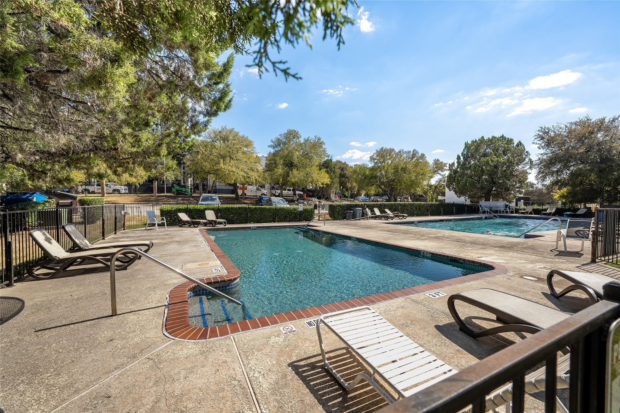 a view of a swimming pool with lounge chairs