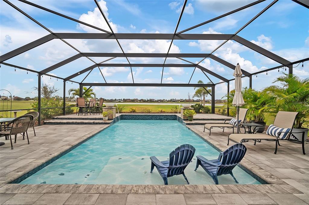 a view of swimming pool with outdoor seating