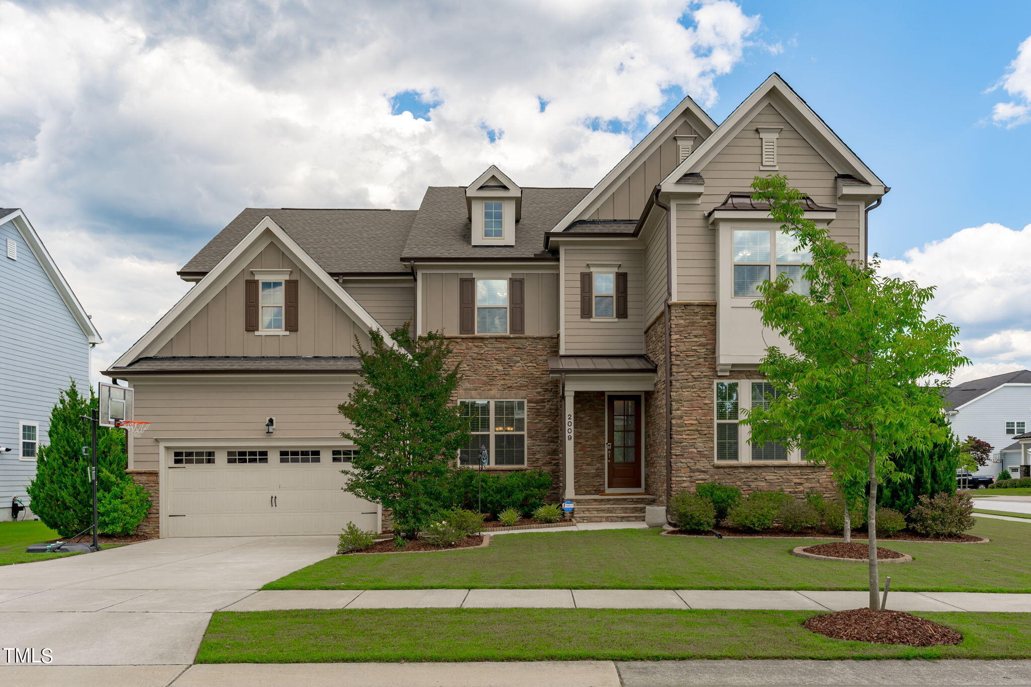 a front view of a house with a yard