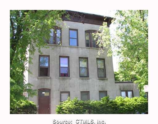 a view of a brick building next to a yard