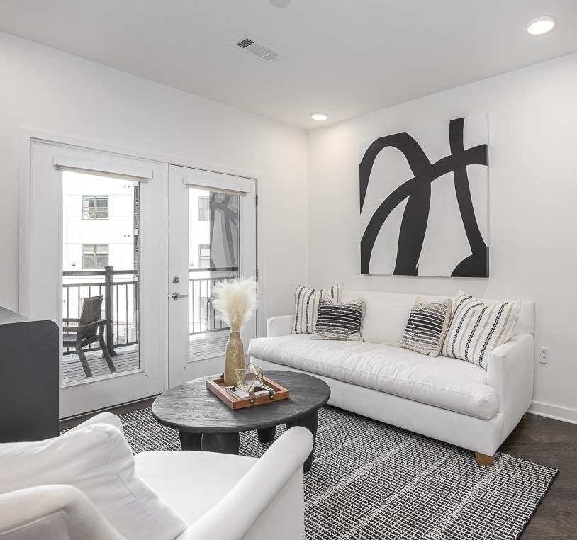 a living room with furniture and wooden floor