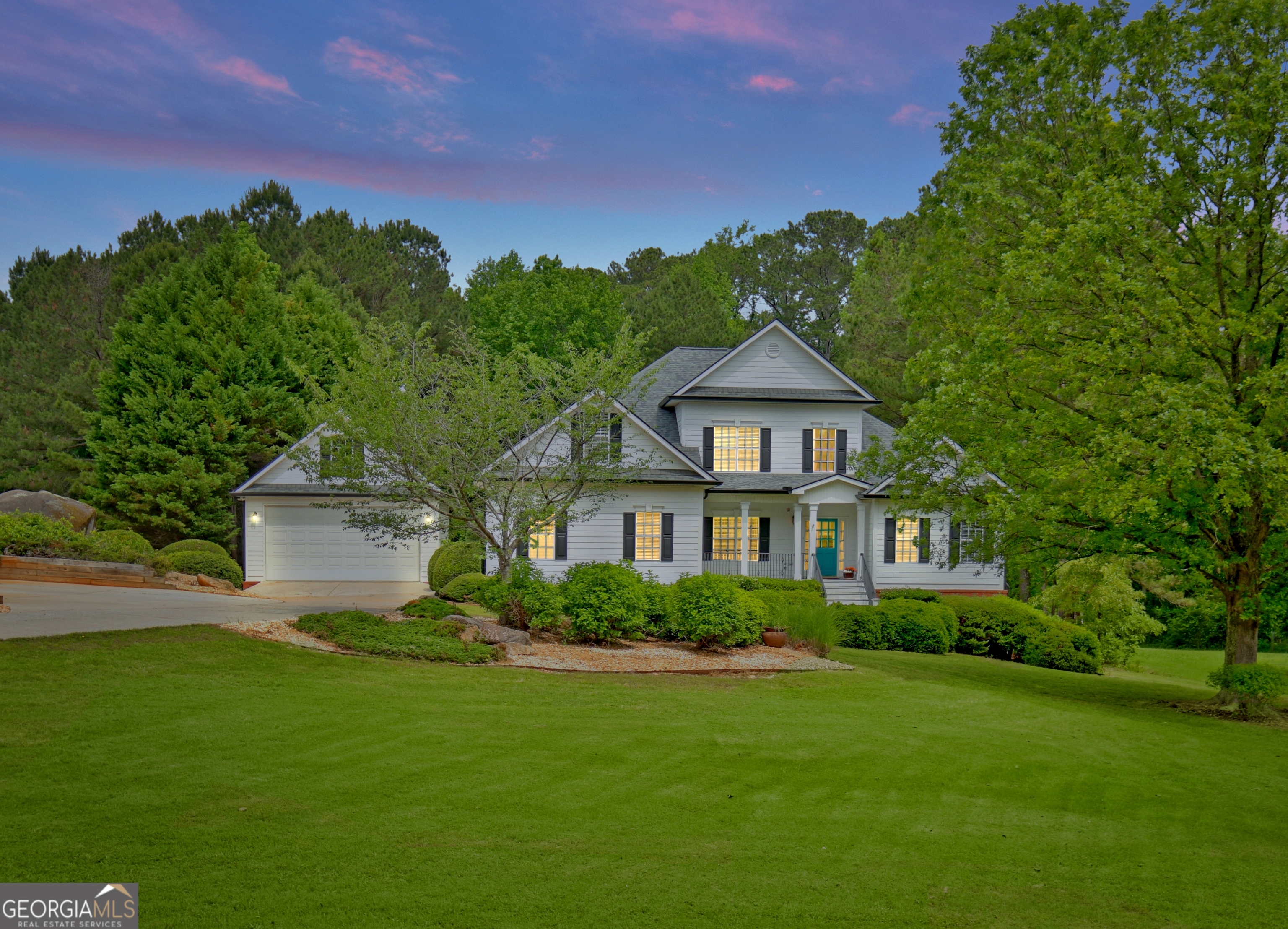 a front view of a house with a garden