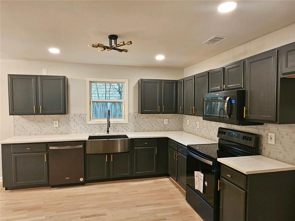 a kitchen with lots of counter space and a sink