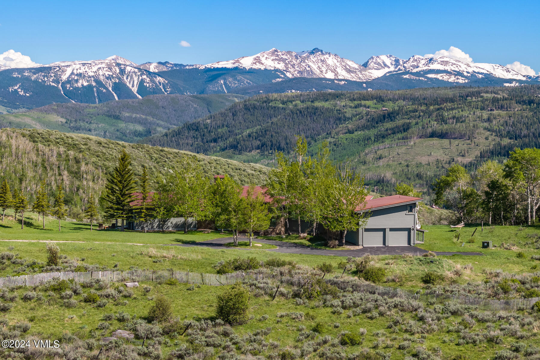 a view of a house with a yard and a forest